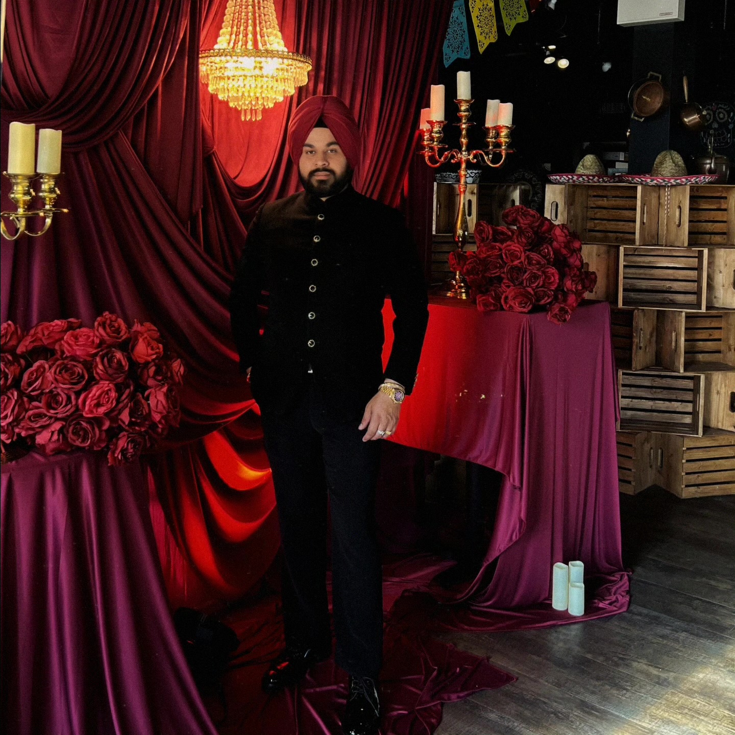 Burgundy draping, florals and chandelier event setting