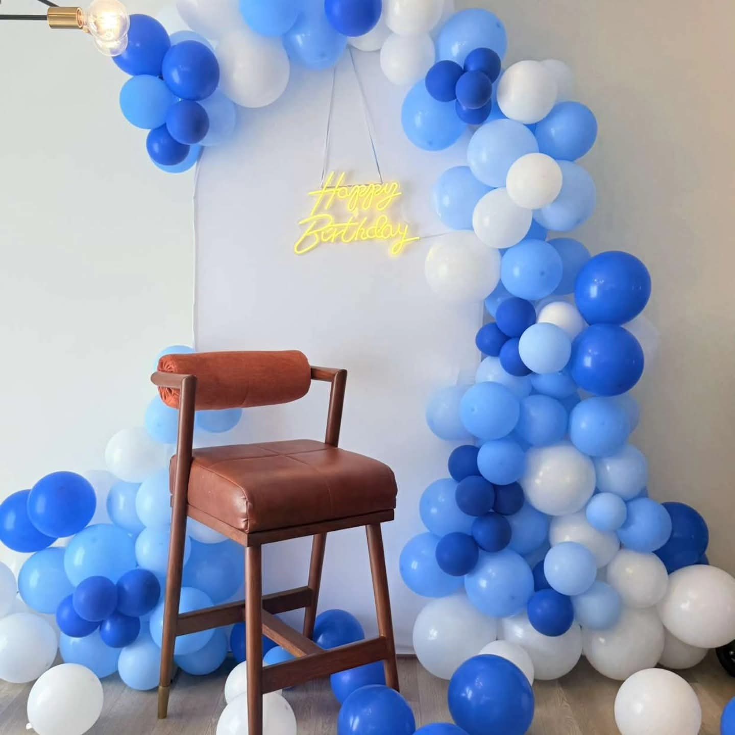 Blue balloon birthday backdrop with neon detailing
